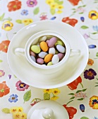 Coloured chocolate almonds in a cup