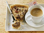 Piece of pecan pie with coffee