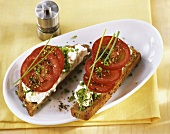 Wholemeal bread topped with tomatoes, fresh cheese, chives
