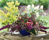 Unusual arrangement of lilac and roses