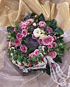 Festive wreath of roses, trailing ivy, asparagus fern etc.