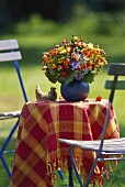 Small round bouquet of roses, tagetes and hydrangea