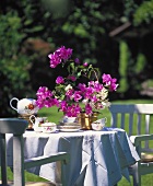 Table in garden with tea set and bougainvillea