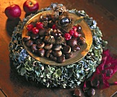 Plate of sweet chestnuts on a wreath of hydrangea flowers