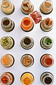 Assorted spices in jars (overhead view)