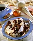 Biscuits with icing sugar and cocoa on gold-rimmed plate