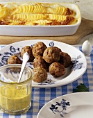Köttbullar (meatballs) with potato gratin and mustard sauce