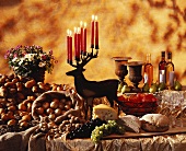 Buffet: potatoes, stag candlestick, grapes, wine, bread etc.