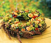 Wreath of roses, seed pods, berries, grasses