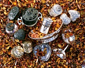 Silver boxes and dishes in a sea of dried flowers