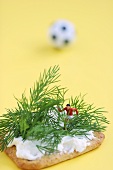 Miniature footballer fighting his way through forest of dill