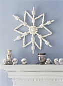 White star as wall decoration and silver balls on mantelpiece