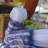 White plastic forks, wrapped in fabric napkins