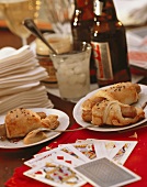Party Table Scene with Pigs in a Blanket and Beer; Cards