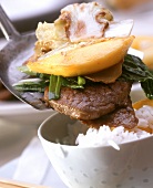 Fried beef slice with vegetables, mango; bowl of rice