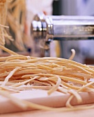 Home-made ribbon noodles on pasta board