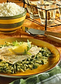 Steamed carp on courgettes and rocket with lemon
