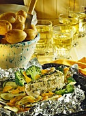 Catfish in foil with vegetables and potatoes