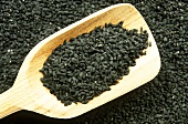 Black cumin with wooden scoop