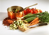 Various vegetables, kitchen knife & pan of diced vegetables