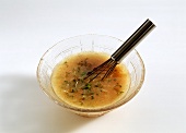 Vinaigrette with garden cress in glass bowl