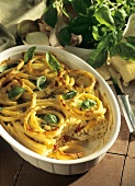 Pasta bake with peppers and basil leaves