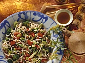 Fried buckwheat noodles with vegetables, tea bowl beside 