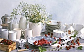 Still life with berries, milk, cream and meadow flowers