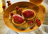 Rose hip tea sorbet dumplings on orange slices in honey sauce