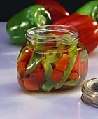 Pickled green and red peppers in jar