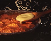 Sweet potato gratin with vanilla sauce on spoon