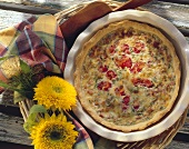 Quiche with Lyoner sausages and tomatoes in baking dish