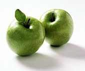 Two Granny Smith Apples; One with Leaf