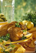 Pollo diavolo (roast chicken with lemon wedges, herbs)
