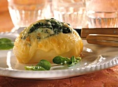 Potatoes stuffed with spinach & cheese on white plate