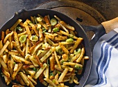 Provencal potatoes in pan with spring onions