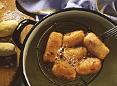 Grandma's croquettes, on ladle above hot oil