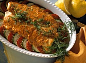 Baked fish with horseradish on tomatoes & courgettes