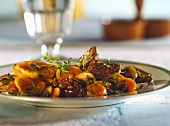 Carrots and morels with potatoes & thyme on plate