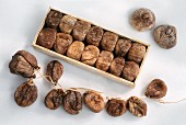 Dried figs in wooden box and on a string