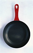 Teflon coated pan with red handle