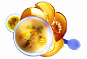 Pumpkin cream soup with apple & chili chutney in soup bowl