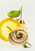 Sole rolls with pesto and slice of orange