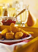 Crunchy cheese fondue with cranberry jam on plate