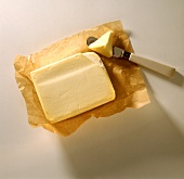 Butter on paper and a piece on butter knife