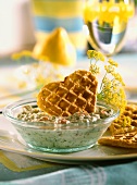 Potato waffles with courgette tzatziki in glass bowl