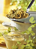 Parsley noodles (spaetzle) with saffron sauce on ladle