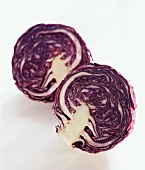 Two red cabbage halves on white background