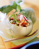 Mixed vegetable salad with herbs in hollowed-out kohlrabi