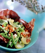 Provencal vegetable salad on radicchio in blue bowl
